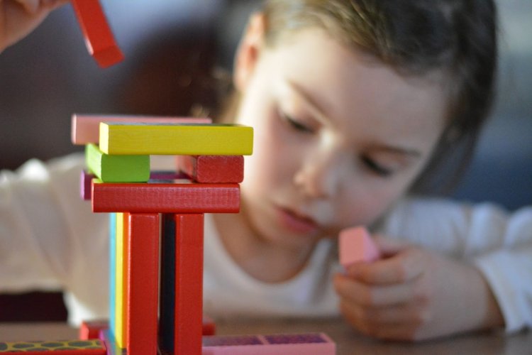 A mesmerizing sight of a child who is totally engrossed with a Montessori material